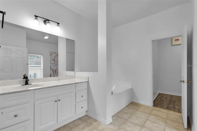 bathroom featuring tile patterned floors, a bathtub, and vanity