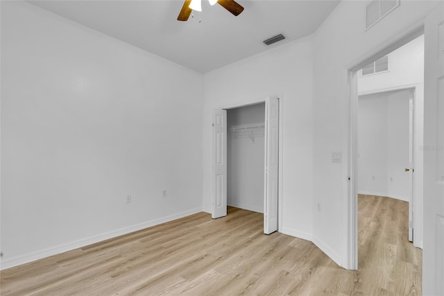 unfurnished bedroom with ceiling fan, light hardwood / wood-style floors, and a closet