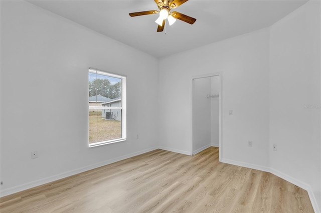 empty room with light wood-type flooring and ceiling fan