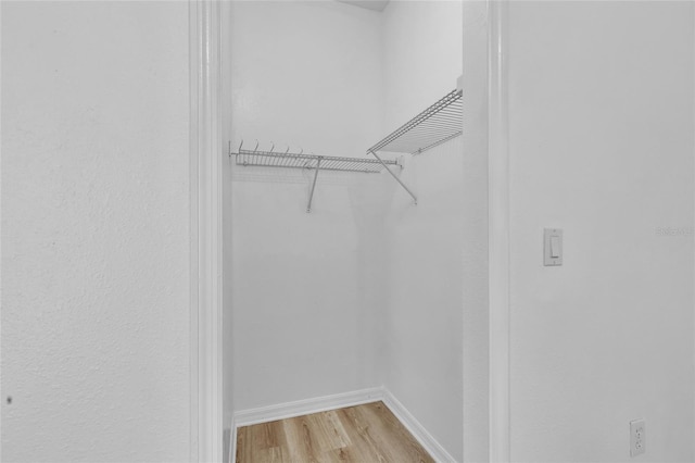 spacious closet with light hardwood / wood-style floors