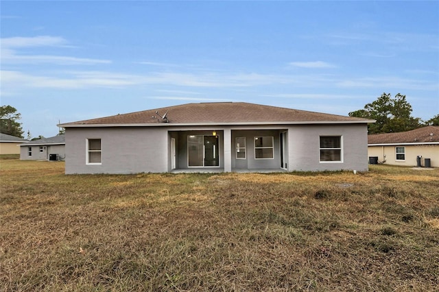 rear view of house featuring a yard