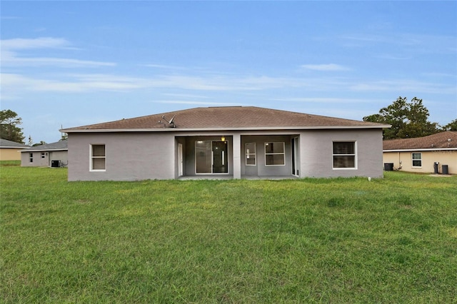 rear view of property featuring a yard