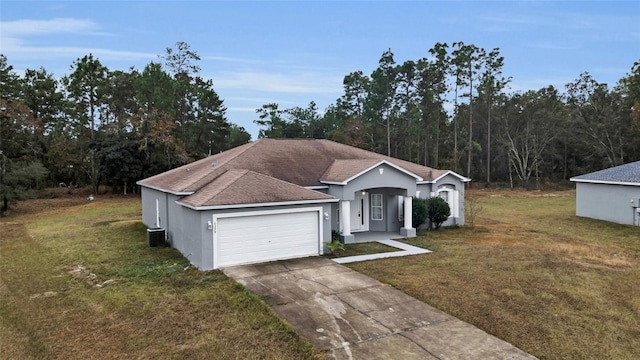 ranch-style house featuring a front yard, a garage, and cooling unit