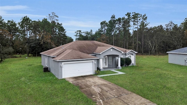 single story home with cooling unit, a front yard, and a garage