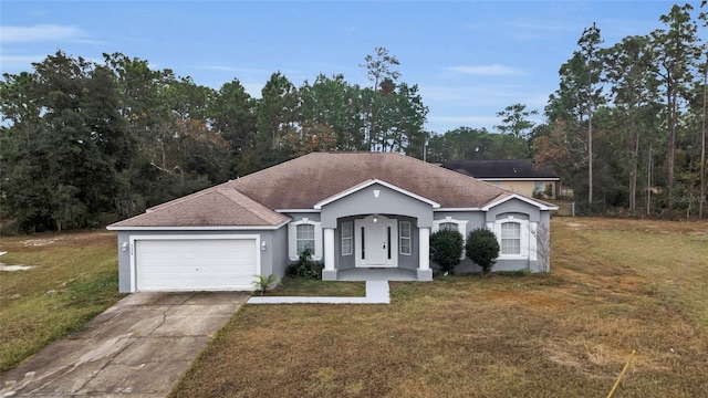 ranch-style house with a garage and a front lawn