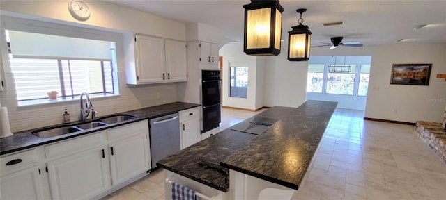 kitchen with sink, stainless steel dishwasher, ceiling fan, tasteful backsplash, and white cabinetry