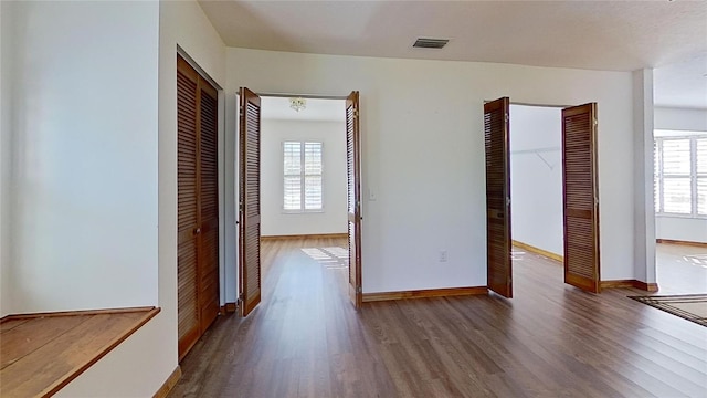 interior space featuring a wealth of natural light and dark hardwood / wood-style floors