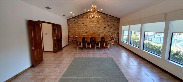 interior space with a chandelier, tile patterned flooring, and lofted ceiling