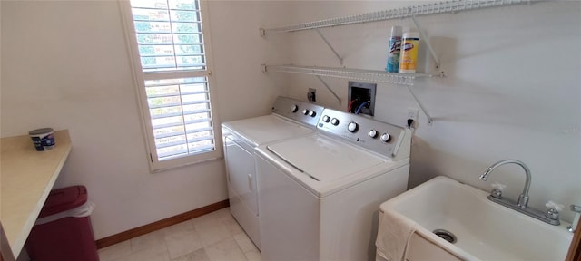 clothes washing area with independent washer and dryer, plenty of natural light, and sink