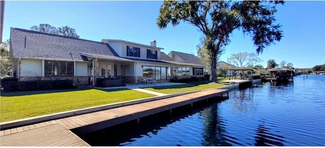 dock area featuring a water view and a yard