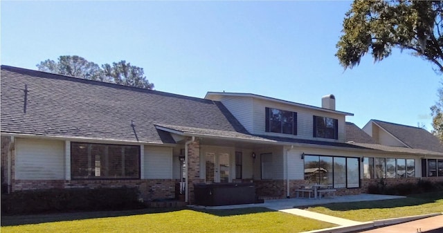 rear view of house featuring a lawn