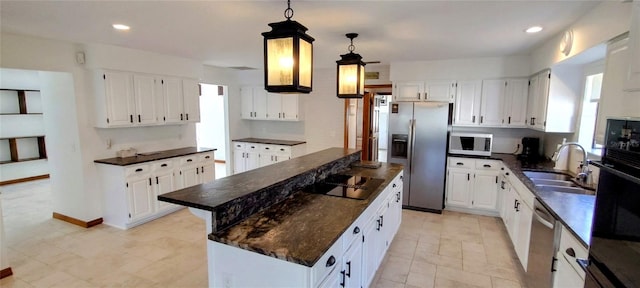 kitchen with white cabinets, a kitchen island, and black appliances