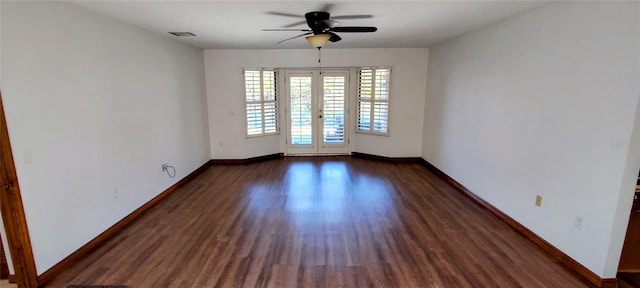 spare room featuring ceiling fan, dark wood-type flooring, and french doors