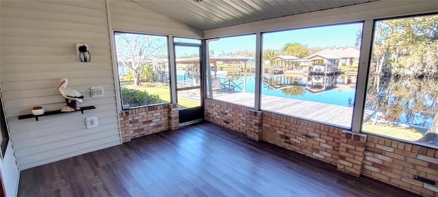 unfurnished sunroom with a water view and lofted ceiling