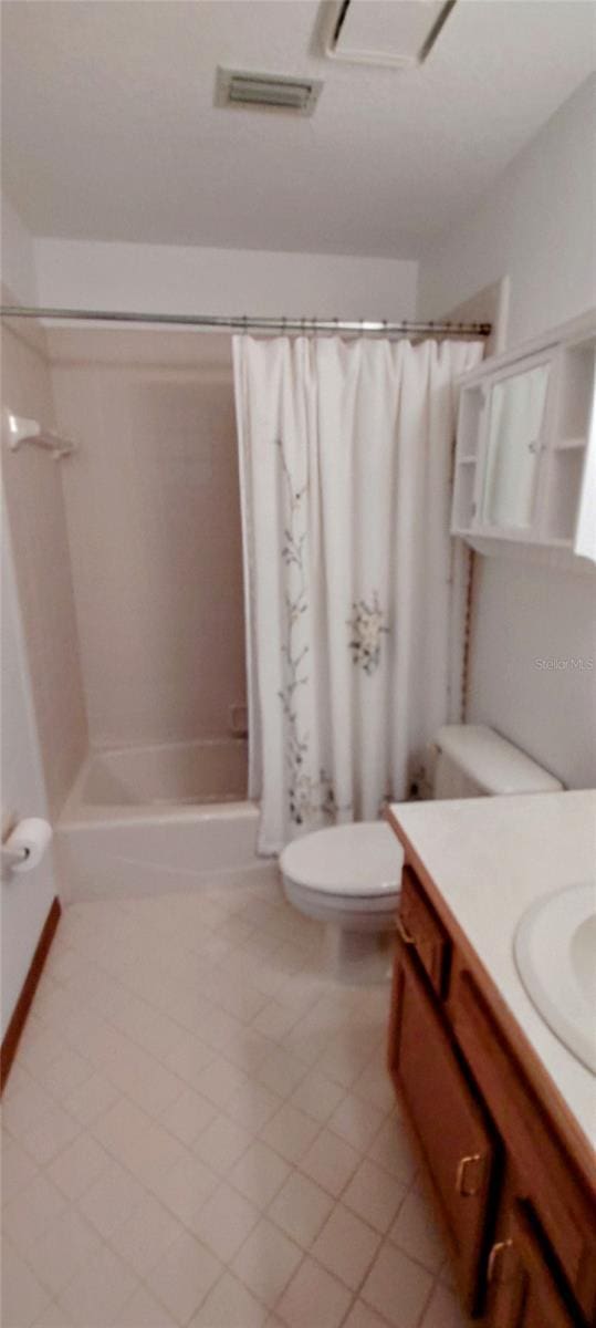 full bathroom with shower / bathtub combination with curtain, tile patterned flooring, vanity, and toilet