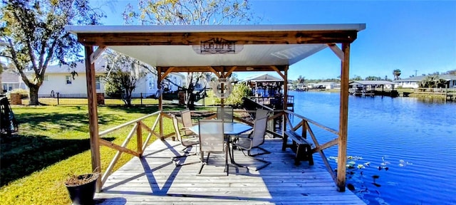 dock area with a yard and a water view