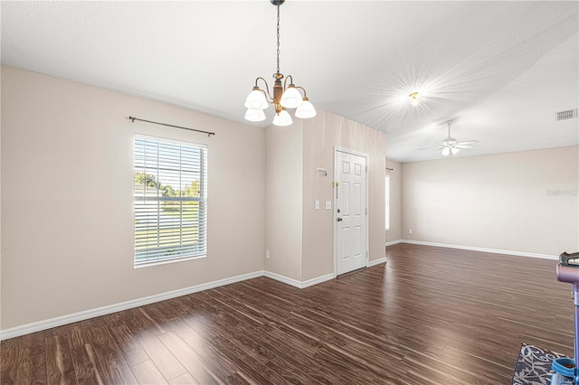 empty room with ceiling fan with notable chandelier and dark wood-type flooring