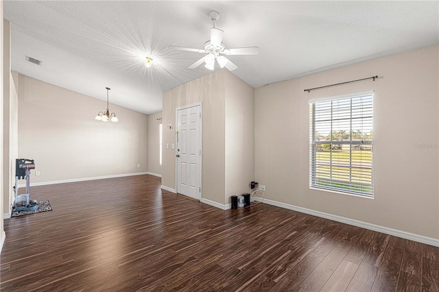 empty room with ceiling fan with notable chandelier, dark hardwood / wood-style floors, and lofted ceiling