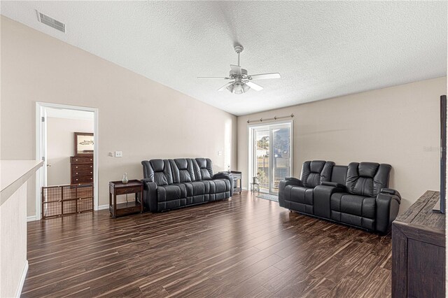 living room featuring a textured ceiling, dark hardwood / wood-style flooring, ceiling fan, and lofted ceiling