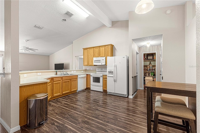 kitchen featuring kitchen peninsula, dark wood-type flooring, white appliances, and vaulted ceiling with beams