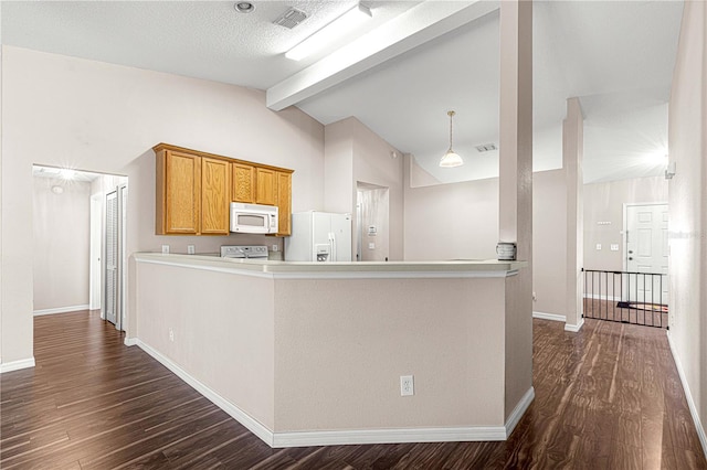 kitchen featuring beam ceiling, dark hardwood / wood-style flooring, white appliances, and kitchen peninsula