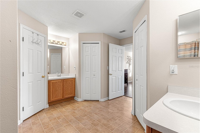 bathroom featuring vanity and a textured ceiling