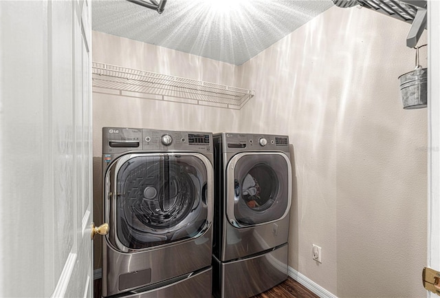 laundry area featuring independent washer and dryer and dark hardwood / wood-style flooring