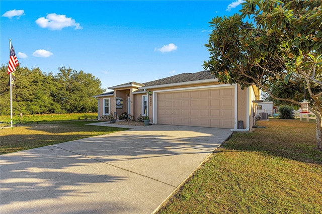 view of front of house featuring central air condition unit, a front yard, and a garage