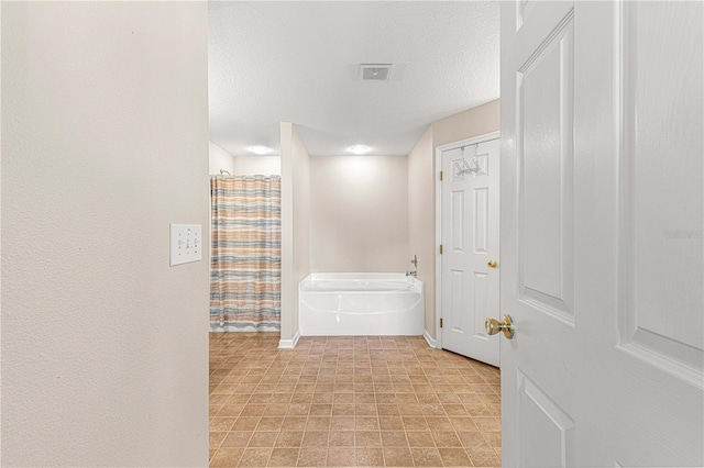 corridor featuring a textured ceiling