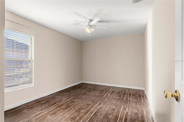 spare room featuring ceiling fan, dark hardwood / wood-style flooring, and a textured ceiling