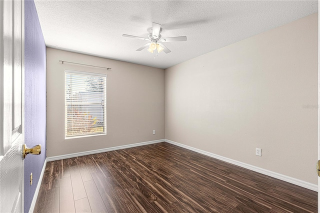 empty room with dark hardwood / wood-style floors, ceiling fan, and a textured ceiling