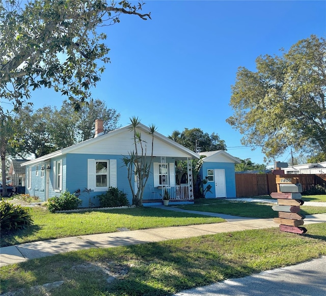 view of front of house featuring covered porch and a front lawn