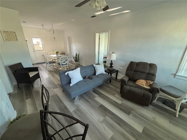 living room featuring ceiling fan and wood-type flooring