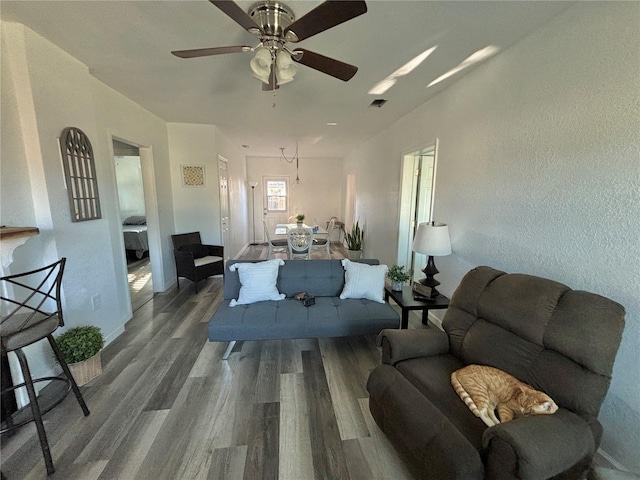 living room featuring ceiling fan and hardwood / wood-style flooring