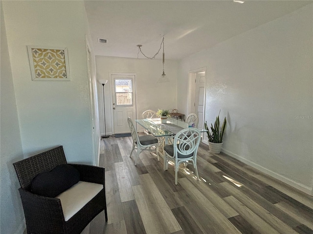 dining room with wood-type flooring