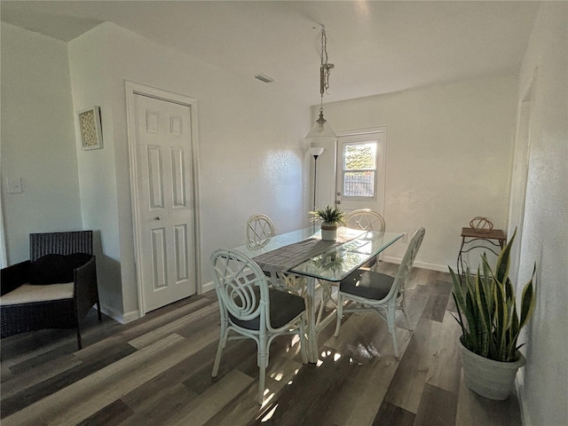 dining space featuring dark hardwood / wood-style flooring