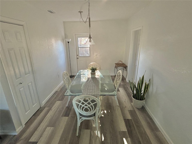 dining area with dark wood-type flooring