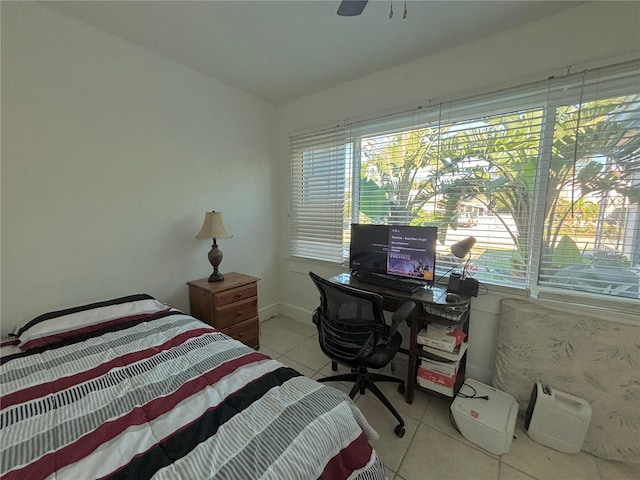 bedroom featuring light tile patterned floors, multiple windows, and ceiling fan