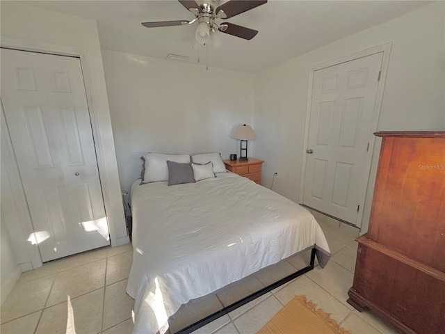 tiled bedroom featuring ceiling fan