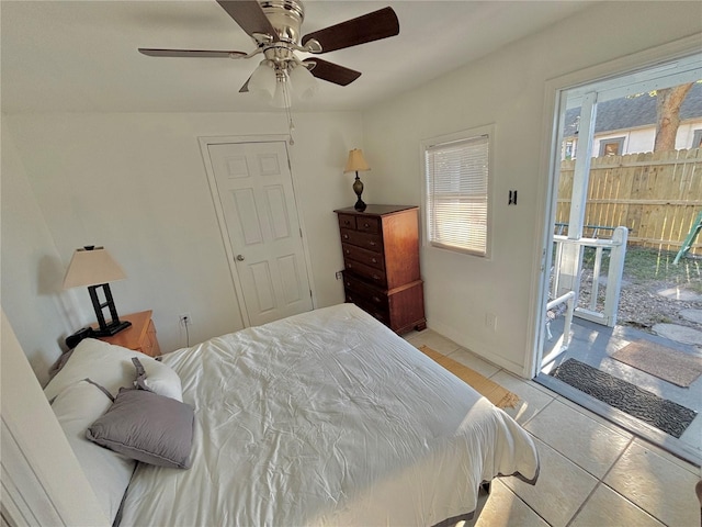 tiled bedroom featuring multiple windows and ceiling fan