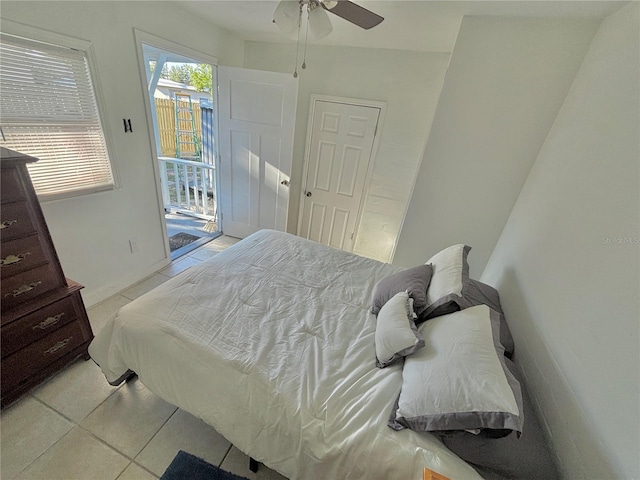 tiled bedroom with access to outside and ceiling fan