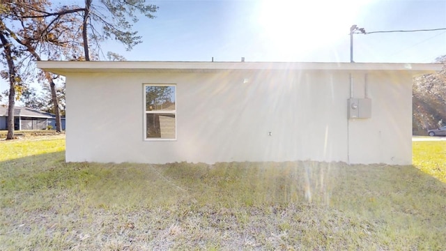 view of side of home with a lawn