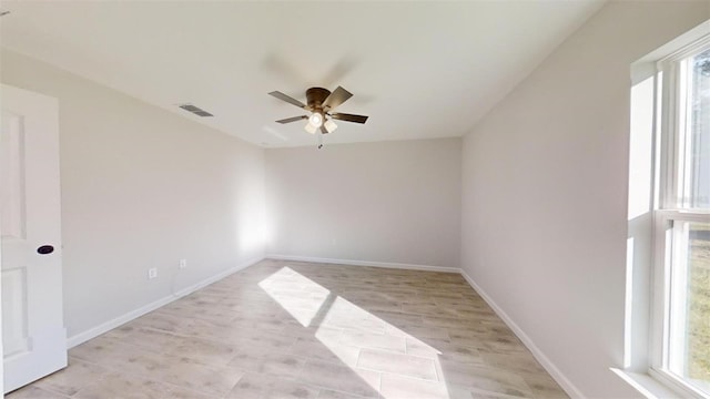 unfurnished room with plenty of natural light and ceiling fan