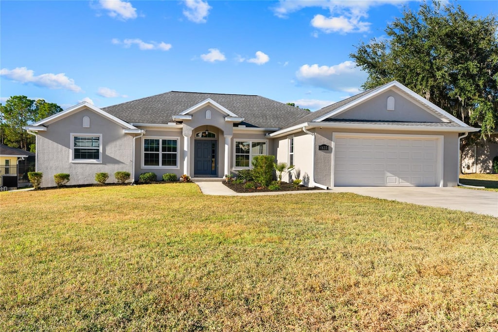 ranch-style home featuring central air condition unit, a front yard, and a garage