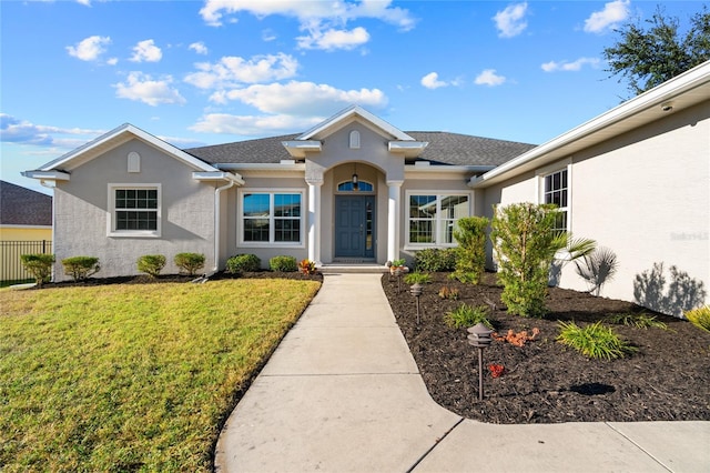 single story home featuring a front yard