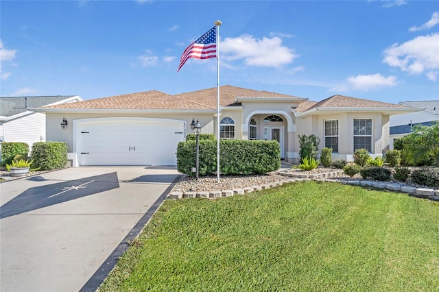 view of front of property with a front lawn and a garage