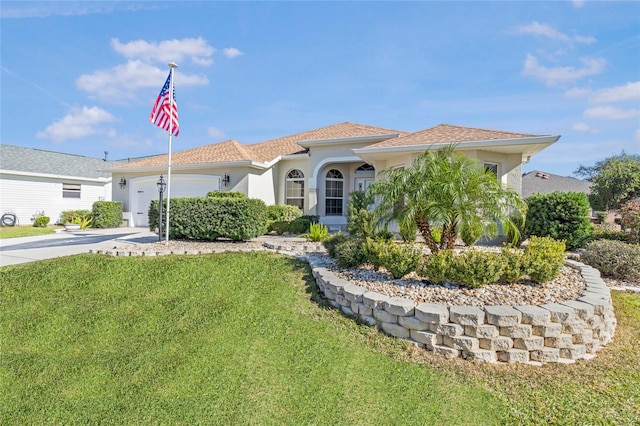 mediterranean / spanish-style house with a garage and a front yard