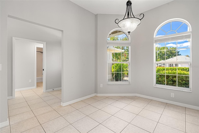 empty room featuring light tile patterned floors and plenty of natural light