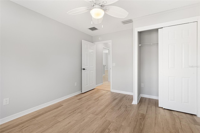 unfurnished bedroom with ceiling fan, a closet, and light wood-type flooring