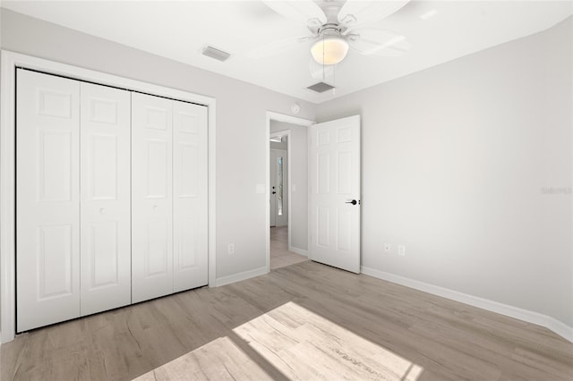 unfurnished bedroom featuring a closet, ceiling fan, and light hardwood / wood-style flooring